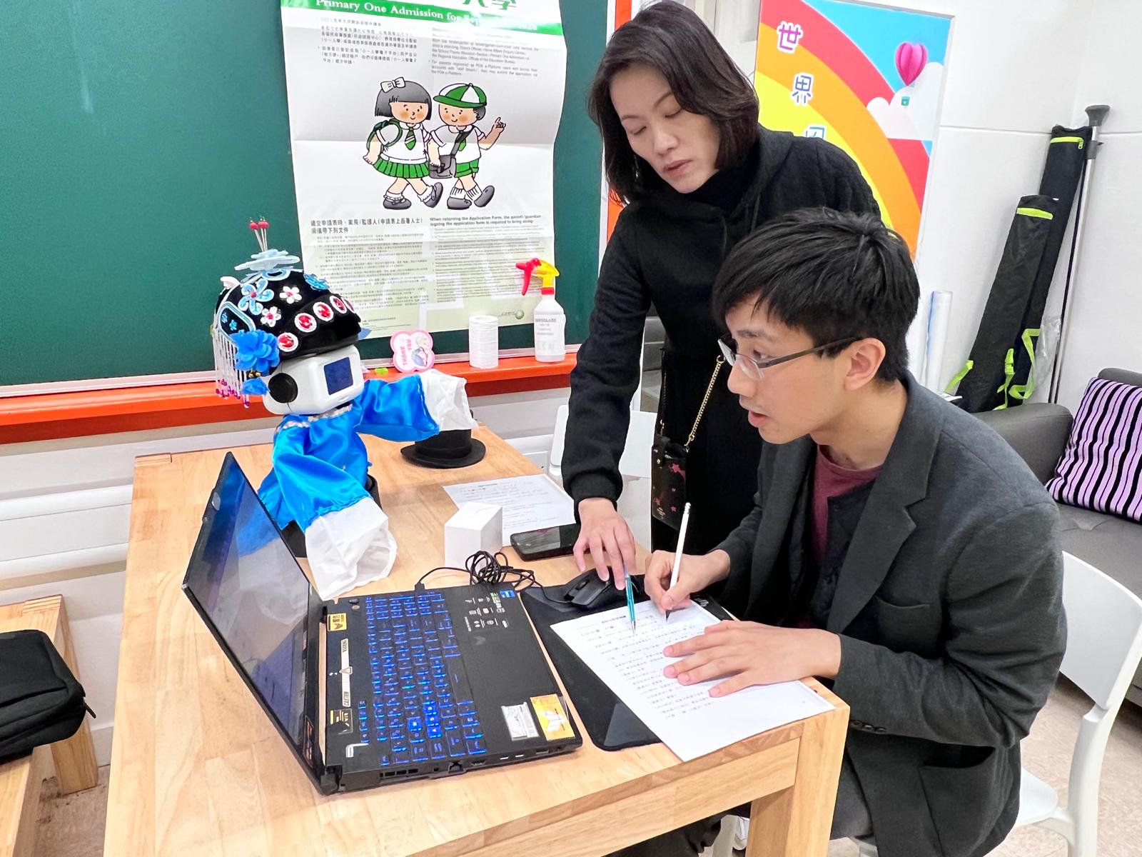A student interacting with a Magos robot at a school activity